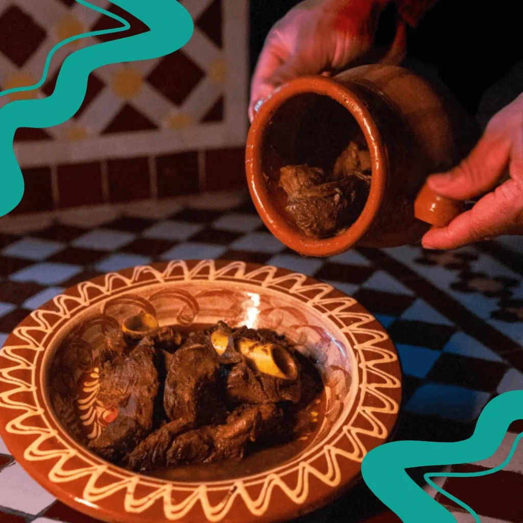 A clay pot filled with Marrakech-style tangia, cooked with tender lamb and aromatic spices.